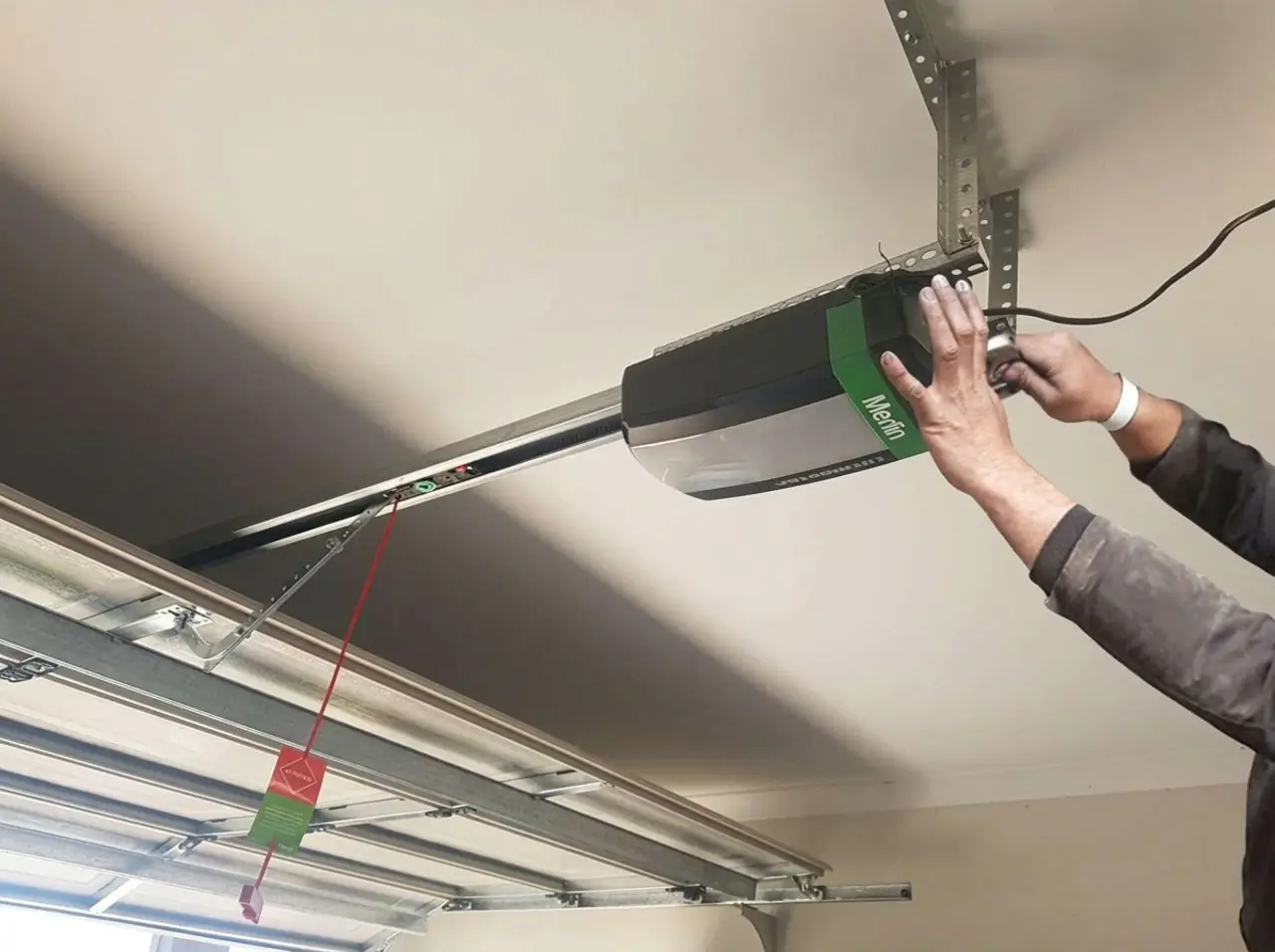 Garage door opener motor installed above a residential door