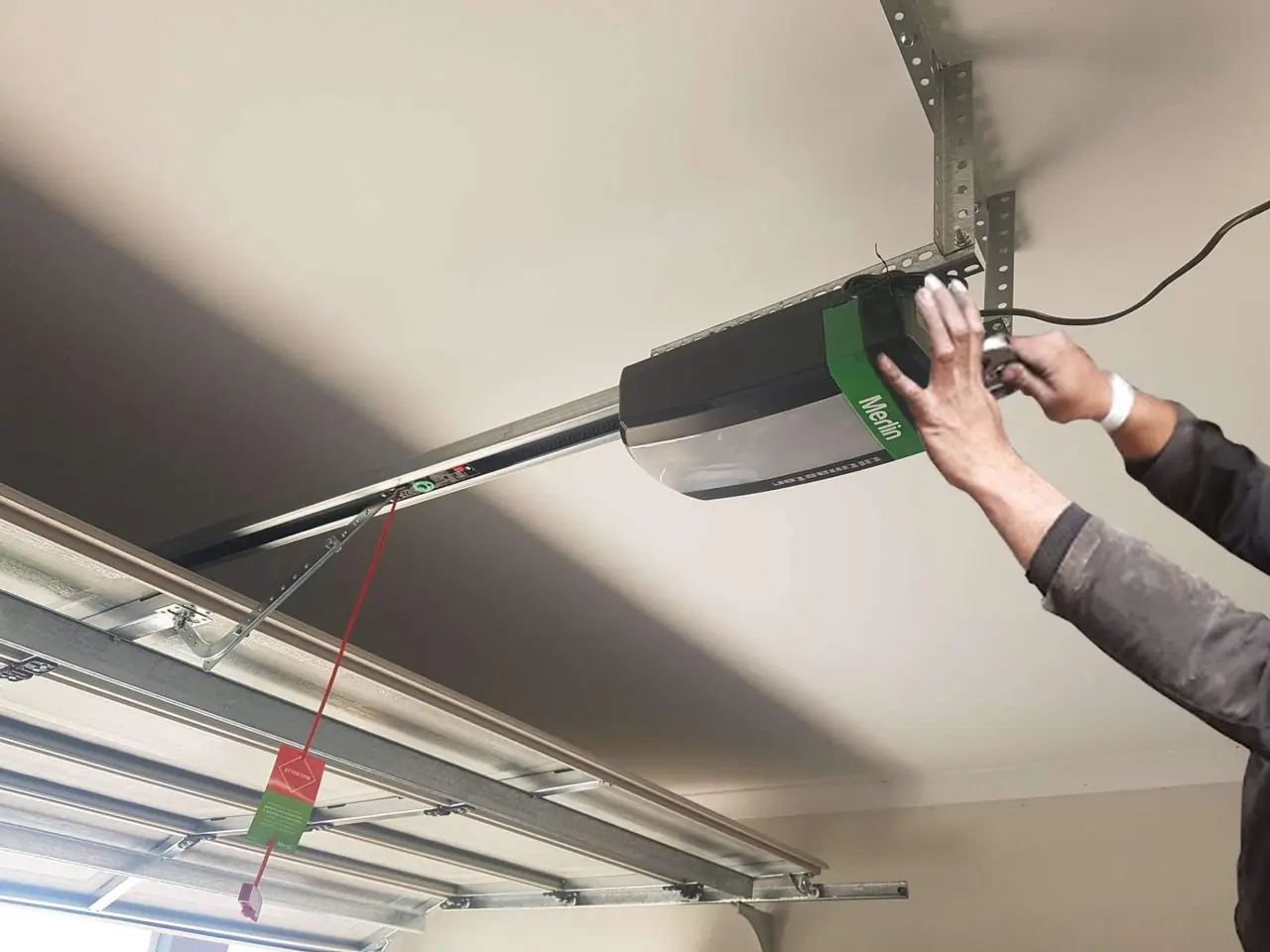 Garage door opener being repaired by a Perth technician